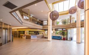 an empty lobby of a building with a largerium at Golden Avenida Family Suites 4* in Salou