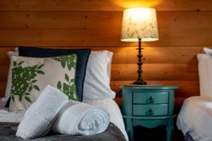 a bedroom with a bed with a nightstand and a lamp at Redlands Country Lodge Apartments with Hot Tubs in Ladybank
