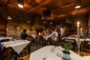people sitting at a table in a restaurant at La Cerreta - Terme di Sassetta in Sassetta