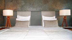 a bed with two pillows on top of it at Casa Geranio in Rio de Janeiro