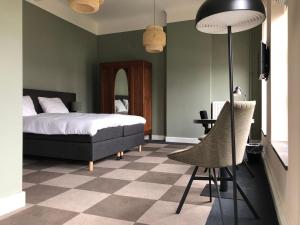 a bedroom with a bed and a checkerboard floor at De Pastorie Bed & Breakfast in Roermond