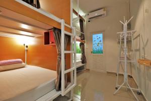 a bedroom with a bunk bed and a ladder at Phuket Numnoi in Bang Tao Beach