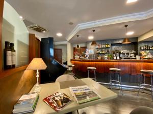 a bar with a table and chairs and a counter at Hostal Bonavista in Cervera