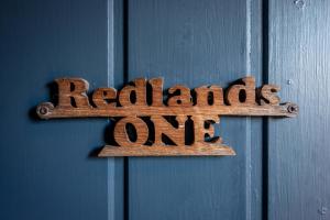 a sign on a door that reads redlands one at Redlands Country Lodge Apartments with Hot Tubs in Ladybank