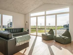 a living room with a couch and two chairs at 12 person holiday home in Haderslev in Haderslev