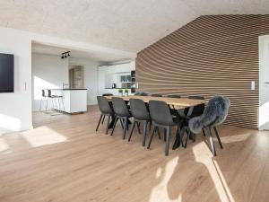 a dining room with a table and chairs at 12 person holiday home in Haderslev in Haderslev