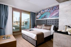 una camera da letto con un letto e un dipinto sul muro di Four Sides Sisli a Istanbul