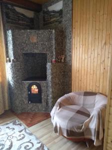 a bedroom with a fireplace and a bed in a room at Карпатські ночі in Yaremche