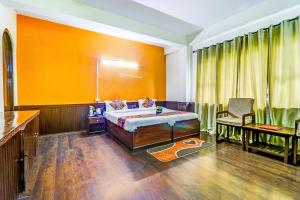 a bedroom with a bed and a table and a chair at FabHotel Oak Ridge Retreat I in Gangtok