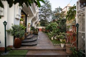 a hallway of a house with potted plants at Milestone 251 in Jaipur