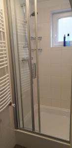 a bathroom with a shower with a glass door at FlipFlop in Noordwijk aan Zee