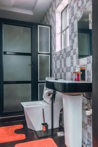 a bathroom with a sink and a toilet at 247 Luxury Hotel in Lekki