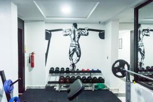 a gym with a statue of a man lifting weights at 247 Luxury Hotel in Lekki