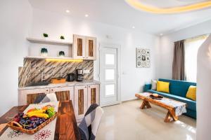 a living room with a table and a blue couch at Abasa Suites in Fira