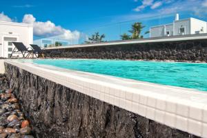 a swimming pool next to a building at Abasa Suites in Fira