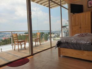 a bedroom with a bed and a view of a balcony at Lavie Villa in Da Lat