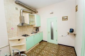 a small kitchen with blue cabinets and a sink at Apartment Ekaterinenskaya 14 in Odesa