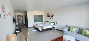 a living room with a bed and a couch at Aranya Resort Koh Lanta in Ko Lanta