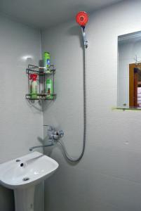a bathroom with a white sink and a shower at Masturabonu Ravshan in Bukhara