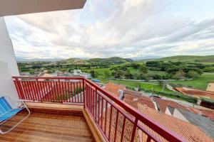 a balcony with a view of the countryside at Pousada Santa Catarina in Cachoeira Paulista