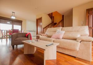 a living room with a couch and a coffee table at Casas encantadoras en entorno espectacular in Portillo
