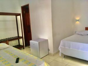 Postel nebo postele na pokoji v ubytování Hotel Pousada Hamburgo