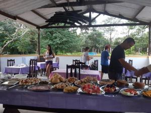 una mesa llena de comida en una mesa púrpura en Pousada Toca da Raposa, en Cavalcante