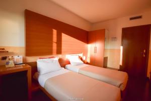 Postel nebo postele na pokoji v ubytování Hotel Quo Vadis