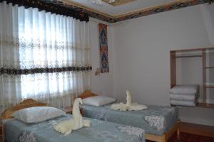 מיטה או מיטות בחדר ב-Khiva Karim Sulton