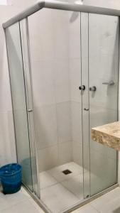 um chuveiro com uma porta de vidro na casa de banho em Hotel Pousada Hamburgo em Porto Seguro
