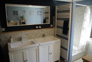 a bathroom with two sinks and a mirror at Waldblick in Bleckede +16 photos