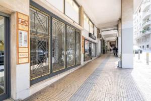 a hallway of a building with glass windows at Studio in the city center, Syntagma in Athens