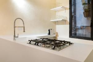 a kitchen counter with a stove and a sink at Pantheon Hedonism in Rome