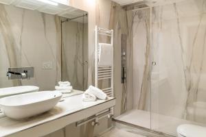 a white bathroom with a sink and a shower at Pantheon Hedonism in Rome +5 photos