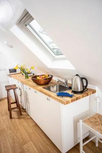 a kitchen with a sink and a skylight at The Barn in Chichester