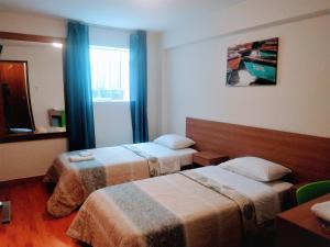 Cama ou camas em um quarto em Hotel Paris Lima