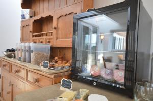 a display case in a kitchen with food in it at Lakeside Old Hunstanton in Hunstanton