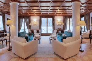 a waiting room with couches and chairs at Grand Hôtel des Alpes in Chamonix