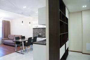 a kitchen and living room with a table and chairs at Apartments u Kremlya in Kazan