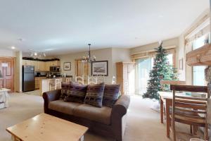a living room with a couch and a christmas tree at The Dakota Outpost in Keystone