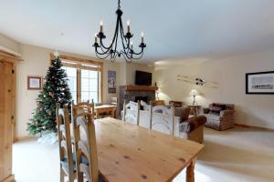 a dining room with a table and a christmas tree at The Dakota Outpost in Keystone