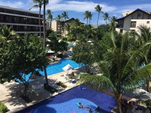 an overhead view of a resort pool with palm trees at Nannai Beira Mar Porto de Galinha 207 in Porto De Galinhas