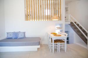 a small bedroom with a bed and a table at Island House Mare in Mylopotas