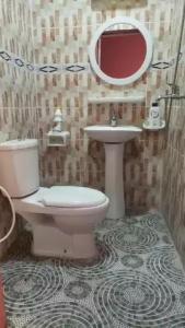 a bathroom with a toilet and a sink at HAKABA in Conakry