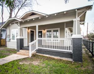 a house with a porch and a white fence at Hackberry St #B Renovated 2BR Near Downtown SA in San Antonio