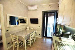 a kitchen with a table and chairs in a room at ...écche se dòrme in Castelvecchio Subequo
