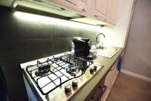 a kitchen with a stove top oven in a kitchen at ...écche se dòrme in Castelvecchio Subequo +2 photos