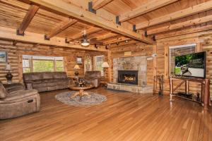 a living room with a couch and a fireplace at Smoky Bear Lodge with Guest House in Sevierville