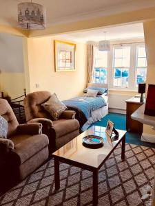 a living room with a bed and a couch at The Old Post Office Boutique Guesthouse in Hythe