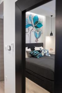 a bedroom with a bed with a painting on the wall at Sweet Dreams-Old Town in Split